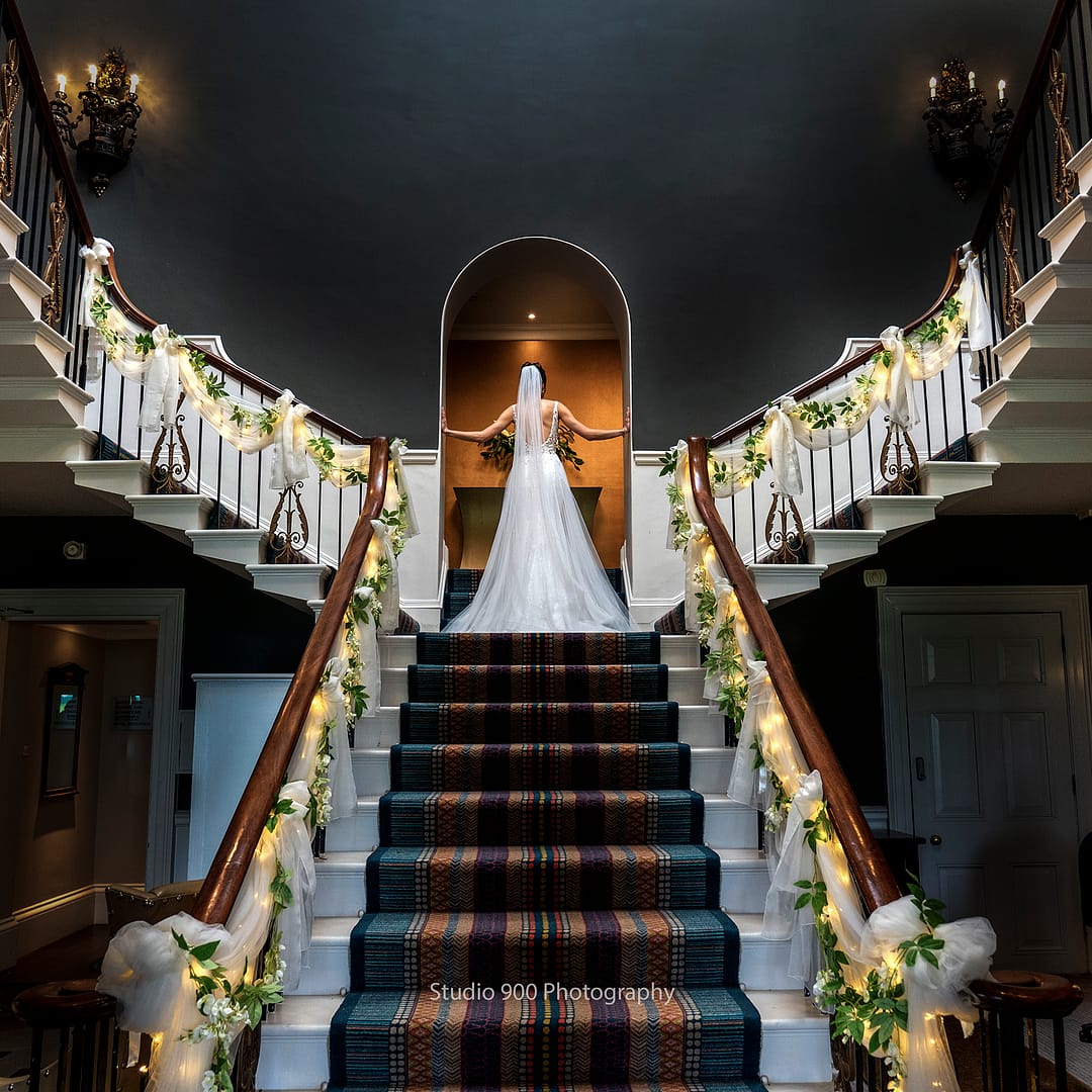Bride at top of amazing staircase
