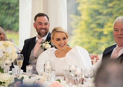 Bride laughing during speeches at Soughton Hall